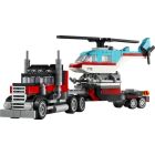 Le camion à plateforme avec un hélicoptère